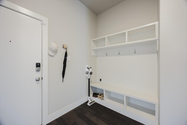 mudroom featuring dark wood-style flooring and baseboards