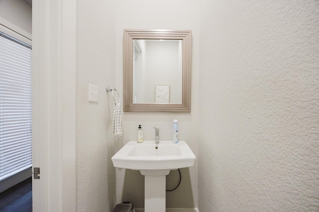 bathroom featuring a textured wall