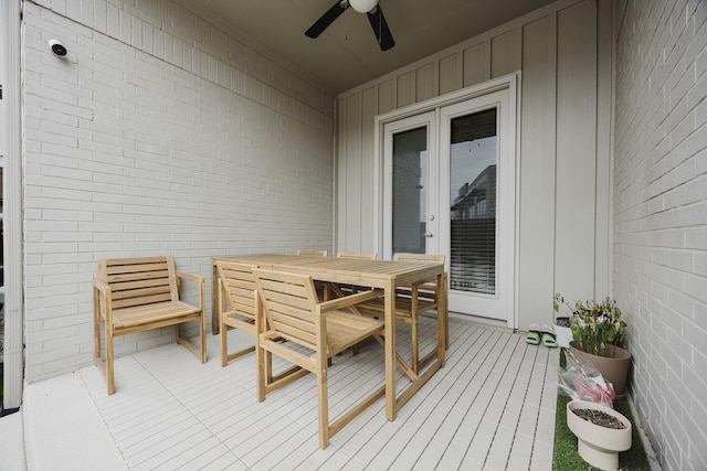 wooden deck featuring a ceiling fan and outdoor dining area