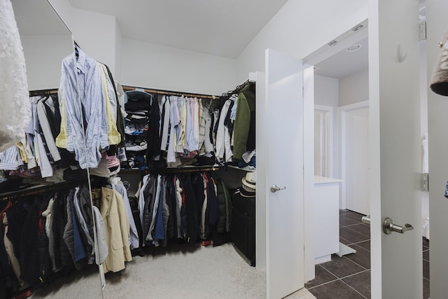 walk in closet with dark tile patterned floors