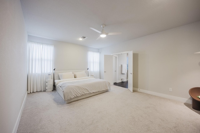 bedroom featuring light carpet, ceiling fan, visible vents, and baseboards