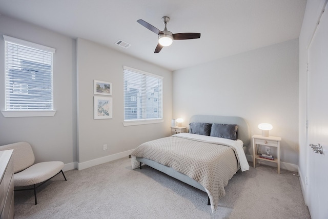 bedroom featuring light carpet, baseboards, visible vents, and ceiling fan