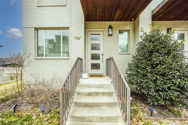 view of exterior entry with brick siding