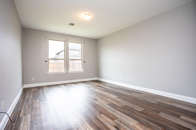 unfurnished room with dark hardwood / wood-style floors