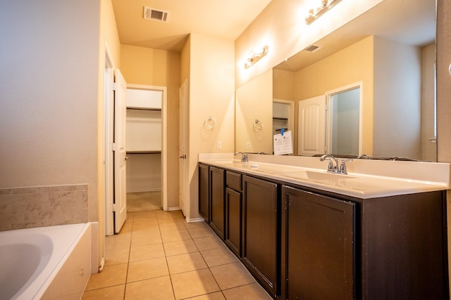 bathroom featuring tile patterned flooring, vanity, and a bathtub