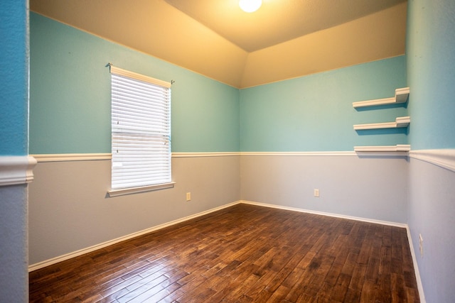 spare room with dark wood-type flooring and plenty of natural light