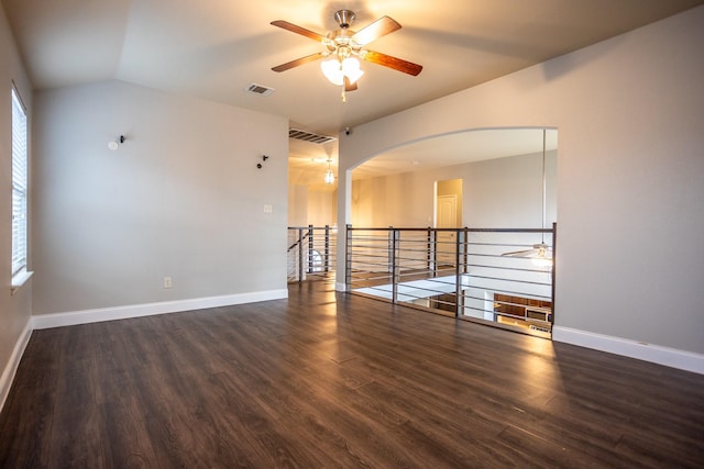 spare room with ceiling fan, lofted ceiling, and dark hardwood / wood-style floors