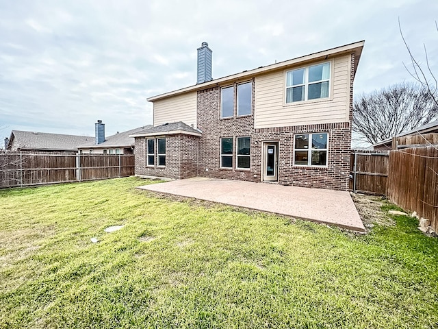 rear view of property with a yard and a patio