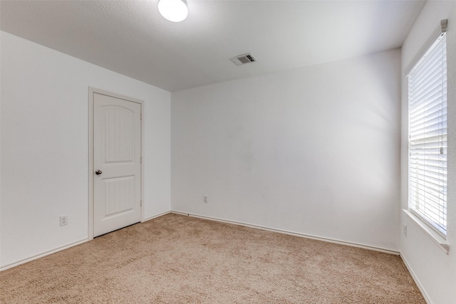 unfurnished room with light carpet