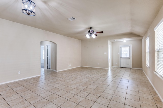 unfurnished living room featuring ceiling fan with notable chandelier and light tile patterned floors