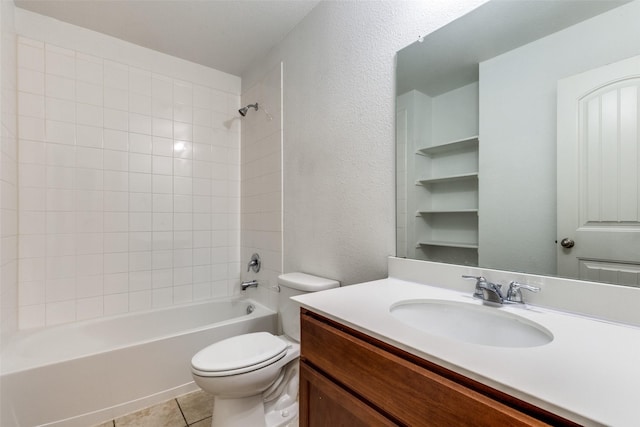 full bathroom with tile patterned floors, toilet, tiled shower / bath combo, and vanity