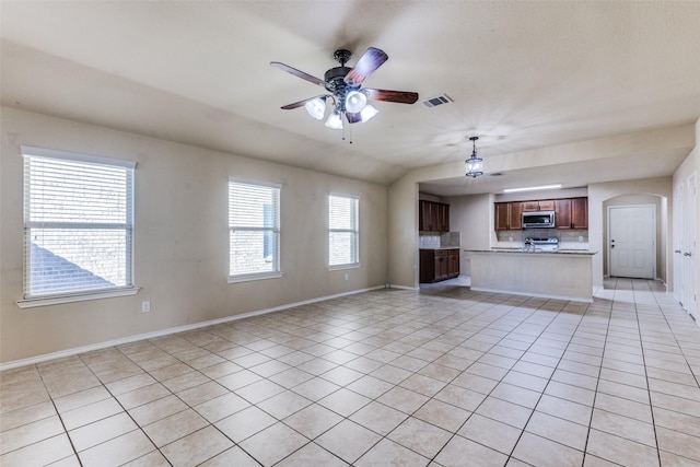 unfurnished living room with light tile patterned floors and ceiling fan