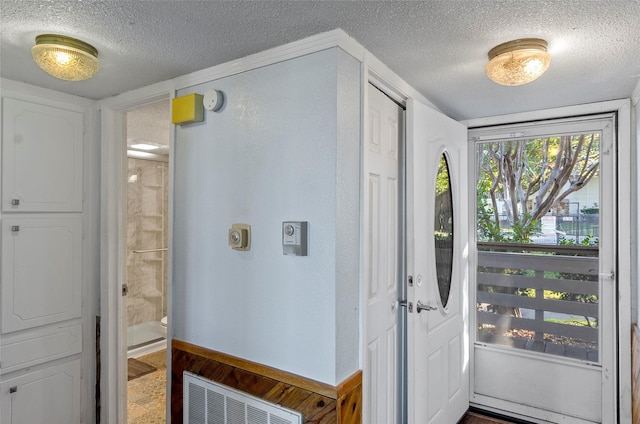 entrance foyer with a textured ceiling