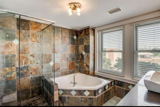 bathroom featuring vanity, independent shower and bath, and tile walls