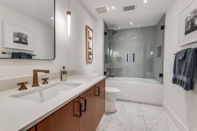 full bathroom featuring tile patterned floors, vanity, toilet, and combined bath / shower with glass door