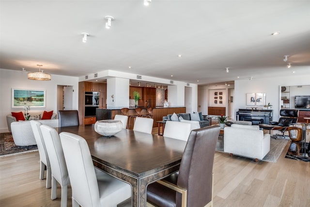 dining space with light hardwood / wood-style floors