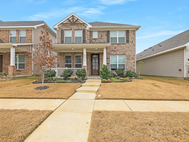 craftsman-style home featuring a front lawn and covered porch