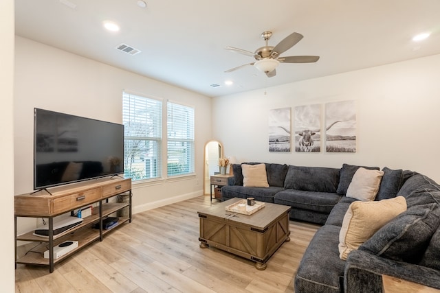 living room with ceiling fan and light hardwood / wood-style floors