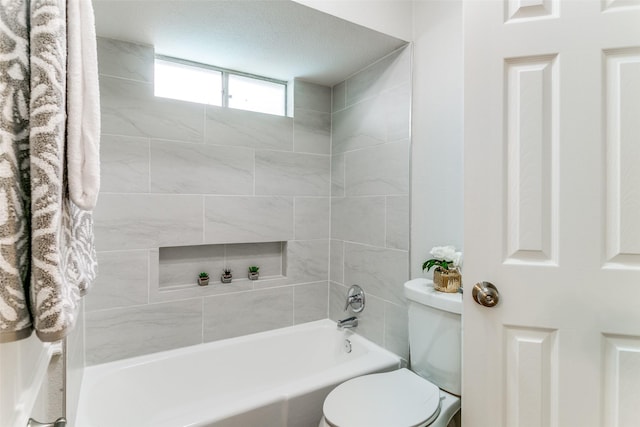 2261 Woodcreek, Carrollton, TX 75006 - bathroom with tiled shower / bath and toilet