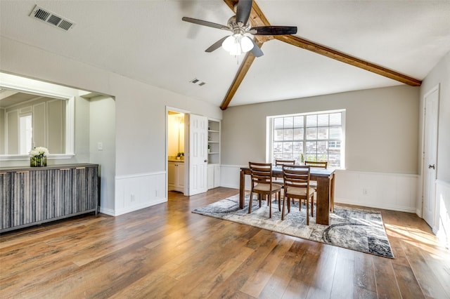 2261 Woodcreek, Carrollton, TX 75006 - dining room with built in shelves, ceiling fan, wood-type flooring, and lofted ceiling with beams