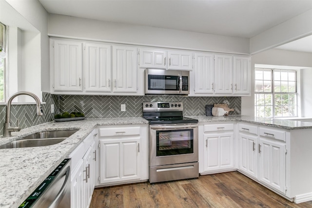 2261 Woodcreek, Carrollton, TX 75006 - kitchen with sink, appliances with stainless steel finishes, dark hardwood / wood-style flooring, light stone countertops, and white cabinets
