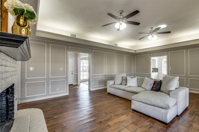 2261 Woodcreek, Carrollton, TX 75006 - living room with ceiling fan, dark hardwood / wood-style floors, and a brick fireplace