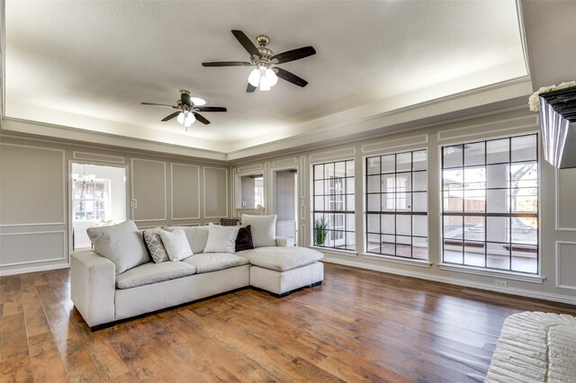 2261 Woodcreek, Carrollton, TX 75006 - living room with a tray ceiling, dark hardwood / wood-style flooring, and ceiling fan with notable chandelier