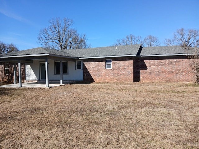 rear view of property featuring a patio and a lawn