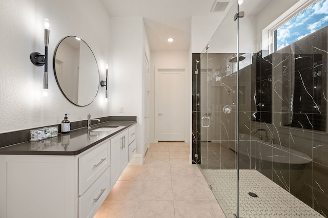 bathroom featuring tile patterned floors, vanity, and an enclosed shower