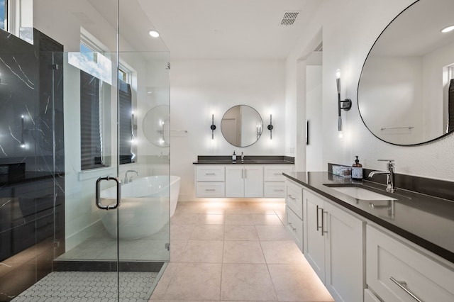 bathroom featuring vanity, tile patterned floors, and plus walk in shower