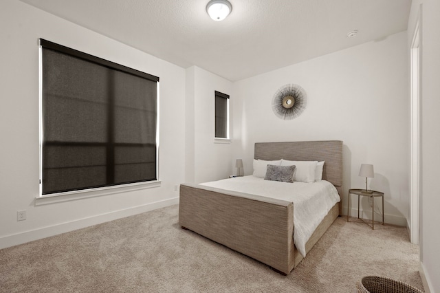 carpeted bedroom with a textured ceiling