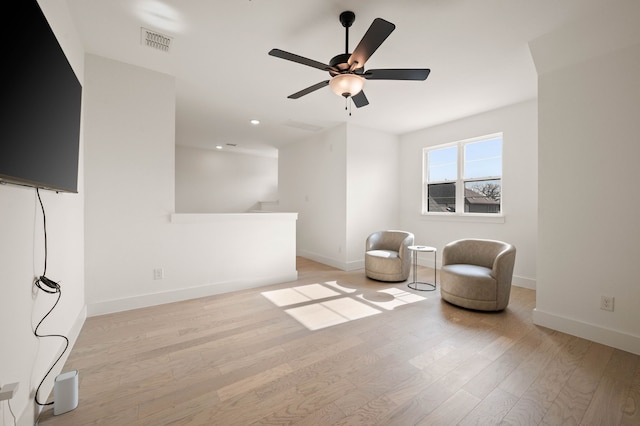 sitting room featuring light hardwood / wood-style floors and ceiling fan