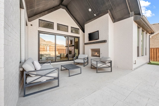 view of patio with an outdoor living space with a fireplace