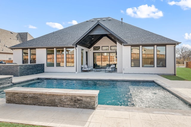 back of property featuring a fenced in pool and a patio