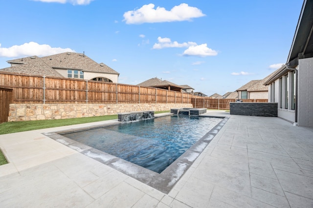 view of pool with an in ground hot tub, pool water feature, and a patio