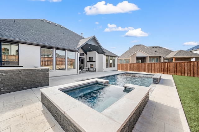 view of pool featuring an in ground hot tub and a patio area