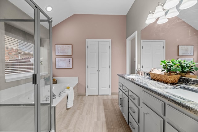 5010 Plantation Ln, Frisco, TX 75035 - full bath with a closet, a bath, double vanity, a shower stall, and vaulted ceiling