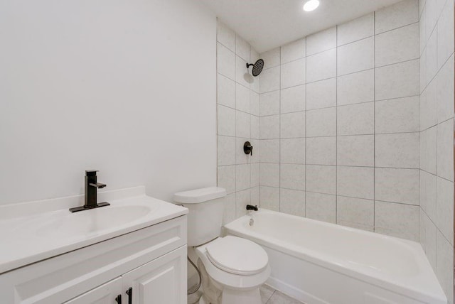 full bathroom featuring tiled shower / bath, vanity, and toilet