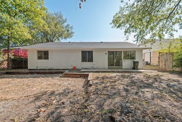 rear view of property featuring central AC and a patio area