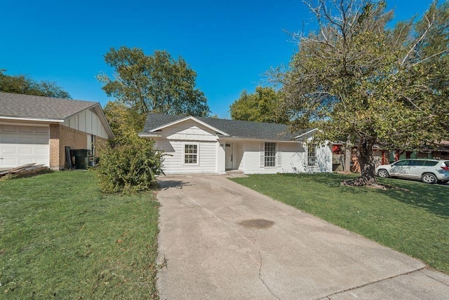 ranch-style house featuring a garage and a front lawn