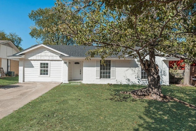 ranch-style house with central AC and a front yard