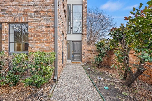 doorway to property featuring brick siding