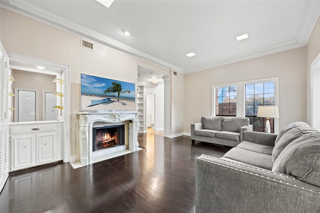 living area featuring ornamental molding, a high end fireplace, and visible vents