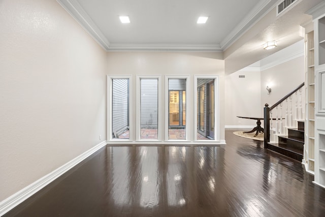 unfurnished room with ornamental molding, visible vents, and baseboards