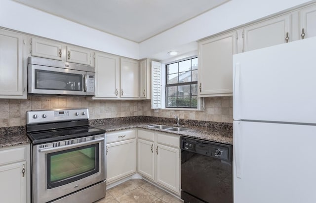 kitchen with appliances with stainless steel finishes, sink, decorative backsplash, and white cabinets