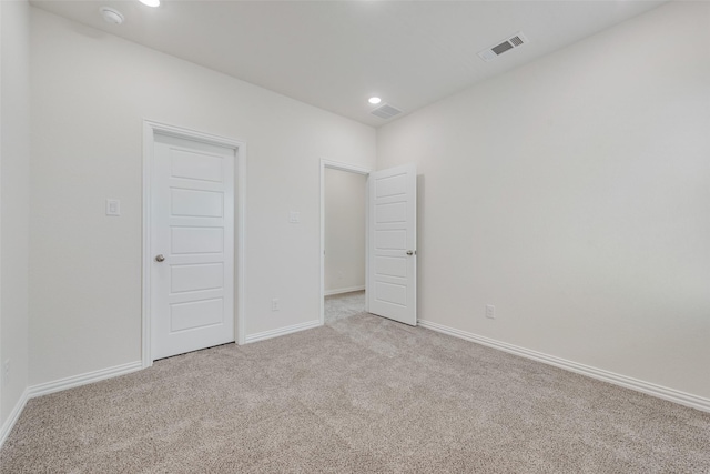 unfurnished bedroom featuring light carpet