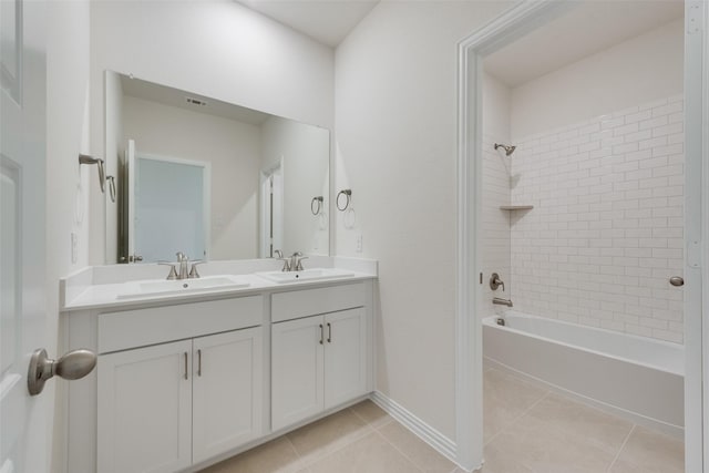 bathroom featuring tiled shower / bath, tile patterned floors, and vanity