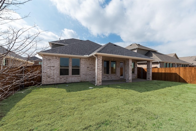 rear view of property featuring a lawn