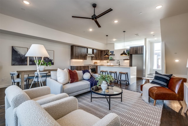 living room featuring ceiling fan, baseboards, dark wood-type flooring, and recessed lighting