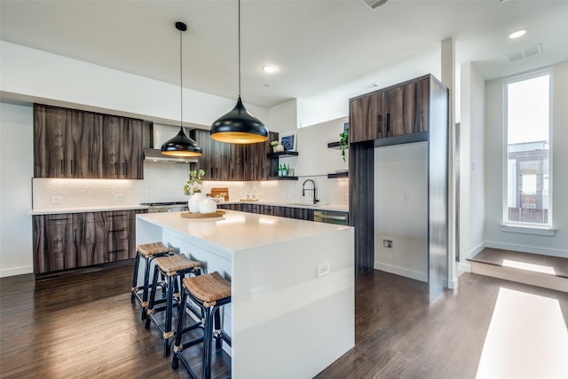 kitchen with modern cabinets, open shelves, wall chimney exhaust hood, a breakfast bar, and dark wood-style floors